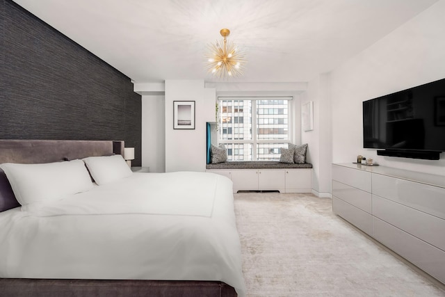 bedroom with an inviting chandelier and light colored carpet