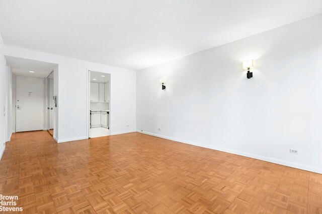 empty room with light parquet floors