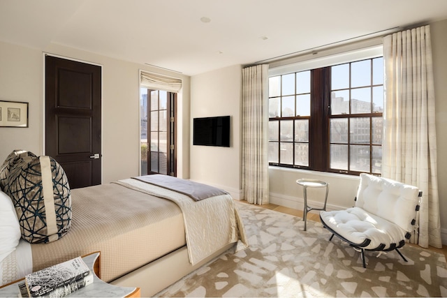 bedroom featuring wood finished floors and baseboards