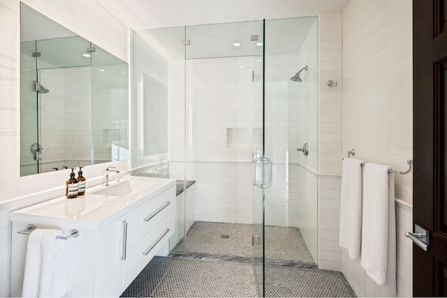 full bathroom with a stall shower, tile patterned flooring, and vanity