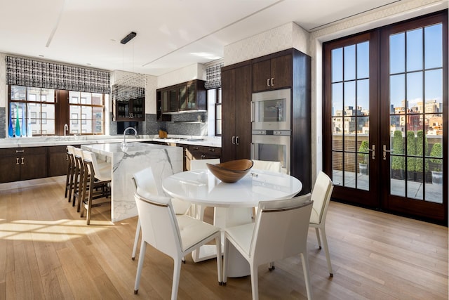 224 Mulberry St Unit 7, New York City, NY 10012 - dining area with french doors and light wood-style floors
