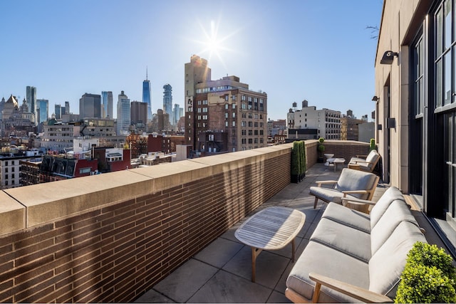 224 Mulberry St Unit 7, New York City, NY 10012 - balcony featuring a view of skyline and an outdoor hangout area