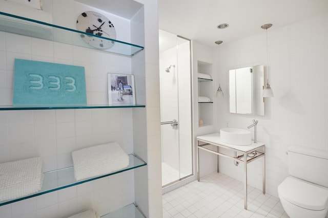 full bathroom with tile patterned flooring, a shower stall, toilet, tile walls, and a sink