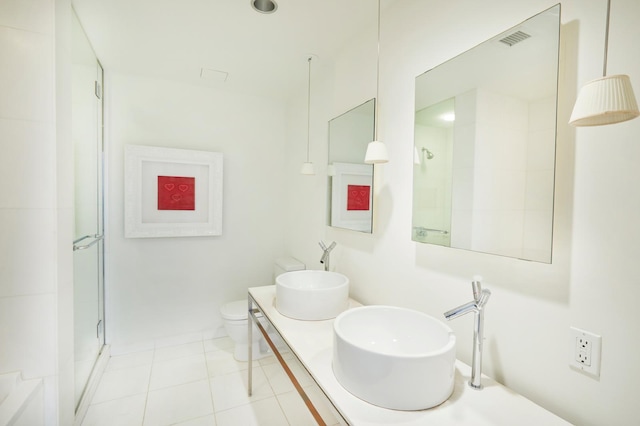 bathroom featuring visible vents, a shower stall, toilet, tile patterned floors, and a sink