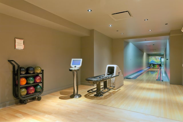 recreation room featuring visible vents, baseboards, recessed lighting, wood finished floors, and a bowling alley