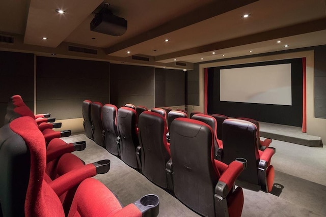 carpeted home theater featuring visible vents, recessed lighting, and beamed ceiling