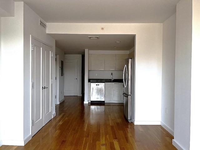 hallway featuring dark hardwood / wood-style floors and sink