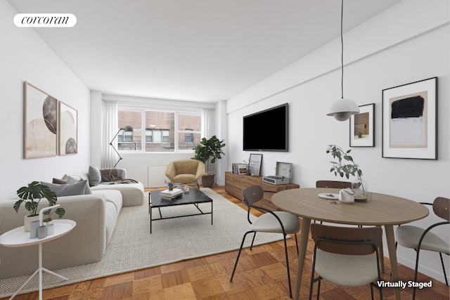 living area with baseboards and visible vents