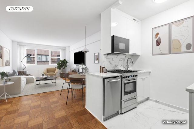 211 E 53rd St Unit 14A, New York City, NY 10022 - kitchen featuring gas stove, white cabinets, a sink, modern cabinets, and tasteful backsplash
