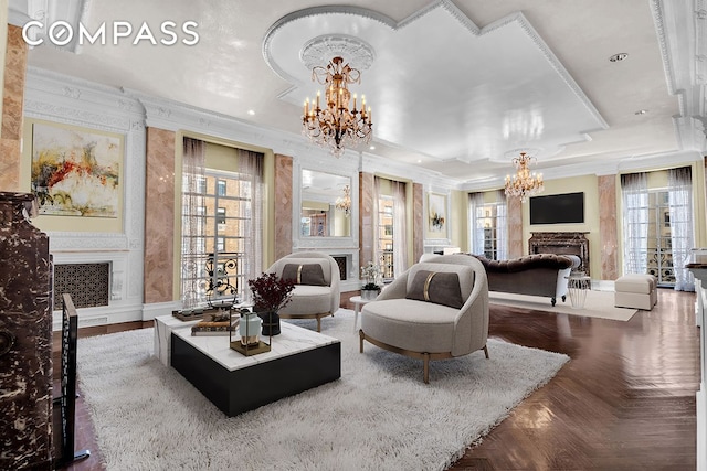 living room with wallpapered walls, recessed lighting, a fireplace, crown molding, and a chandelier