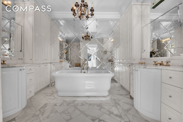 full bathroom featuring marble finish floor, vanity, an inviting chandelier, and ornamental molding