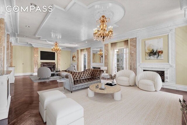 living room with an inviting chandelier, crown molding, and dark parquet floors