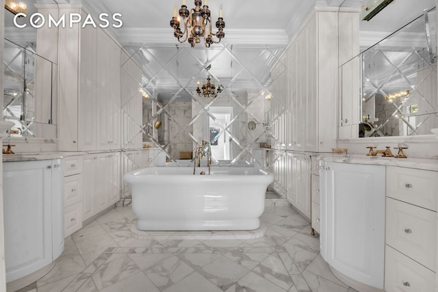 bathroom featuring tile walls, ornamental molding, vanity, a washtub, and an inviting chandelier