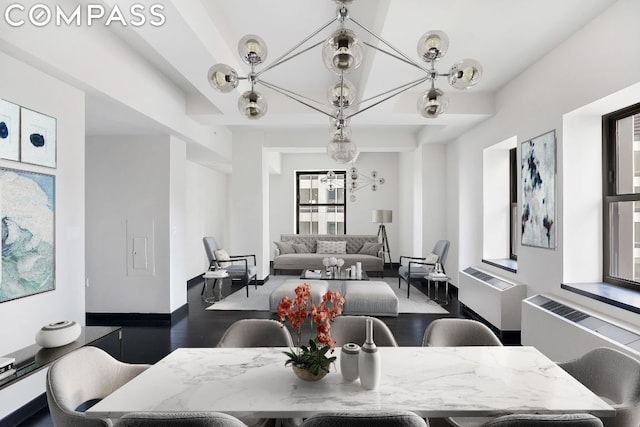 dining space featuring radiator and an inviting chandelier