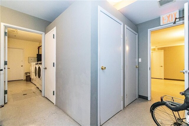 52 3rd Ave Unit 1A, New York City, NY 11217 - corridor featuring separate washer and dryer and light flooring