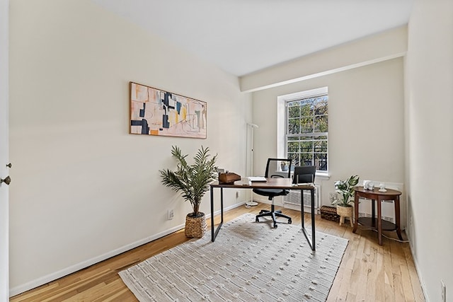 office with baseboards and light wood finished floors