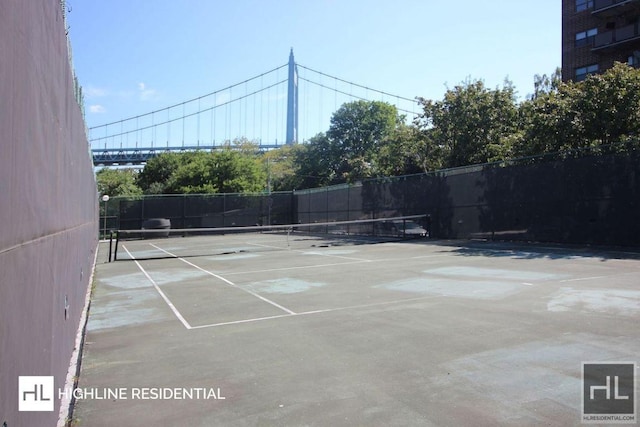 view of tennis court featuring fence