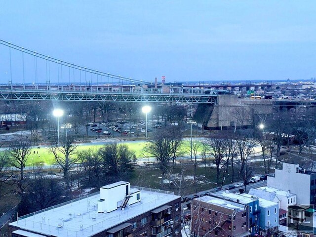 aerial view at dusk featuring a city view