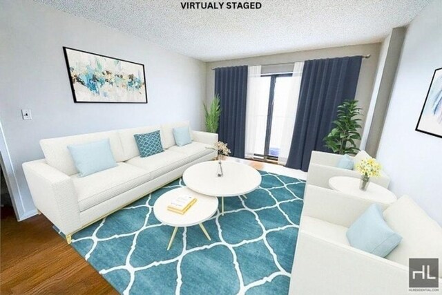 living room with a textured ceiling and wood finished floors