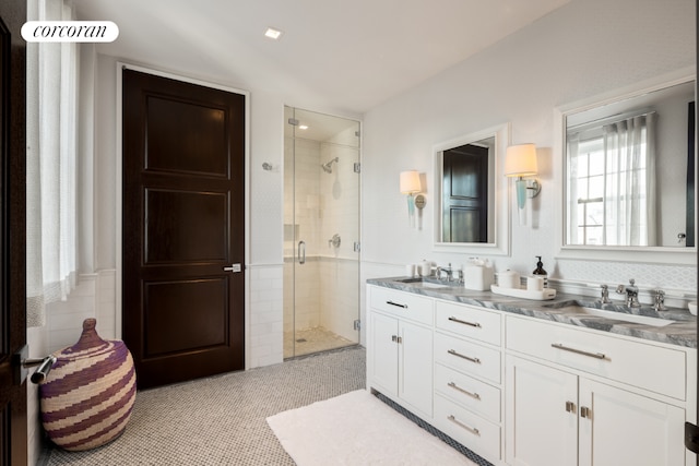 bathroom with vanity and a shower with door