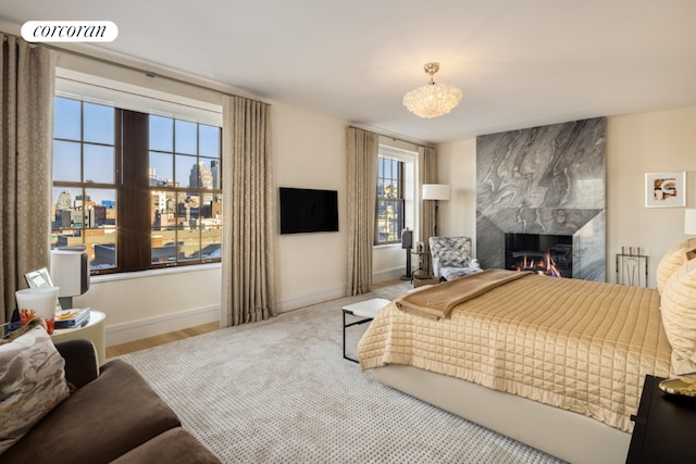 bedroom with an inviting chandelier, a fireplace, visible vents, and baseboards