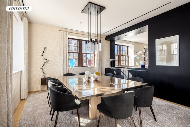 dining area with light wood-type flooring and a chandelier