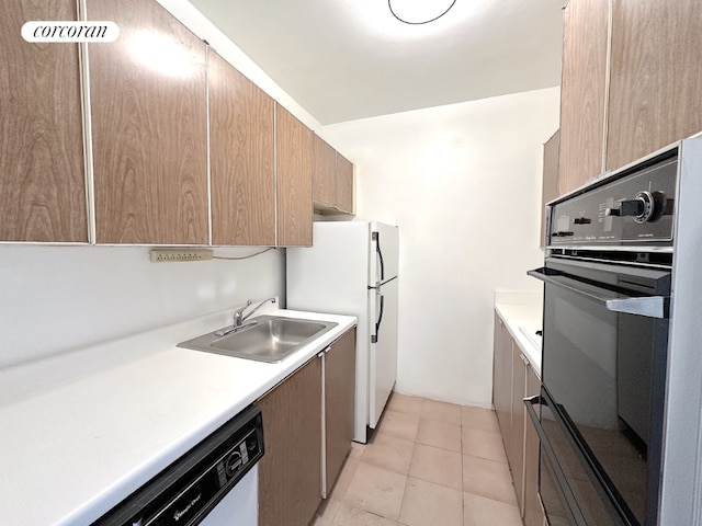 kitchen with white appliances, sink, and light tile patterned floors