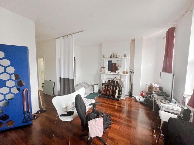 workout room with a baseboard heating unit and hardwood / wood-style floors