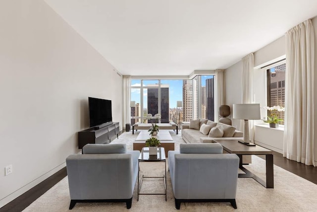 living room with expansive windows and hardwood / wood-style floors