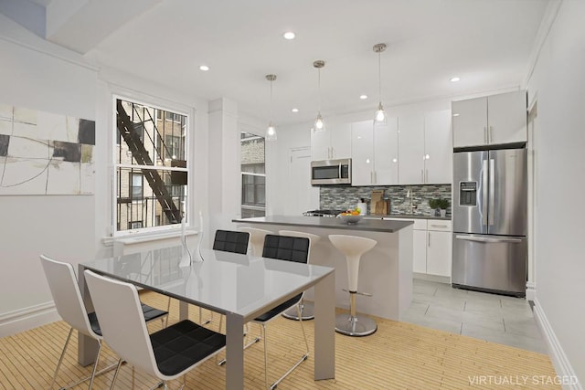 dining space with light tile patterned floors and ornamental molding