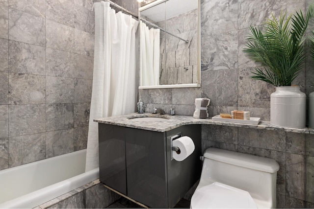 bathroom featuring shower / bathtub combination with curtain, tile walls, toilet, and vanity