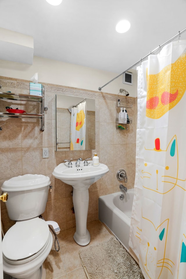 full bath with toilet, tile patterned flooring, visible vents, and tile walls