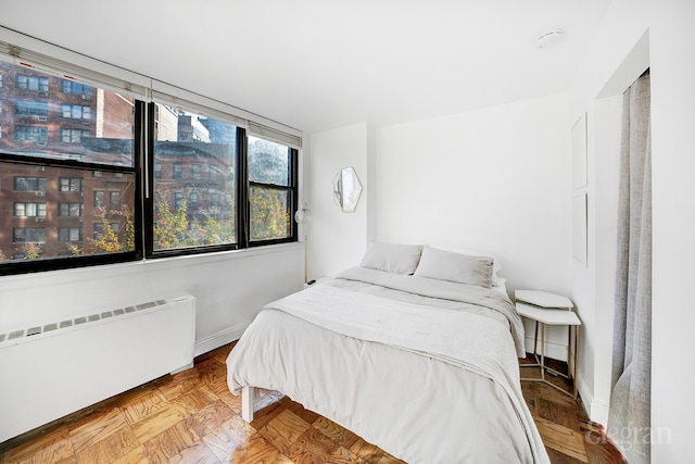 bedroom with baseboards and radiator heating unit