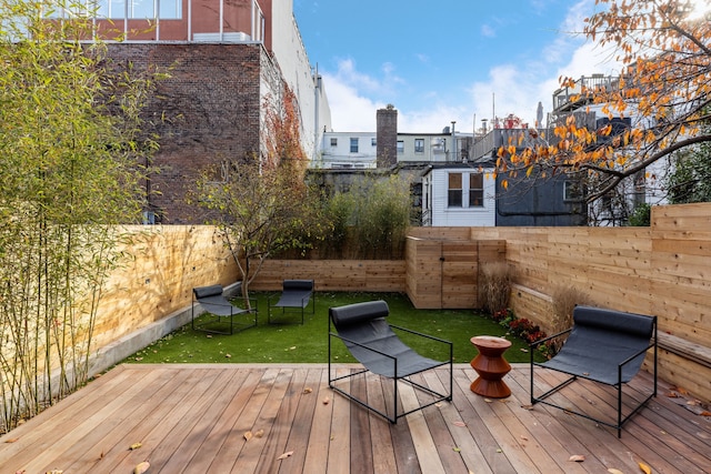 deck featuring a lawn and a fenced backyard