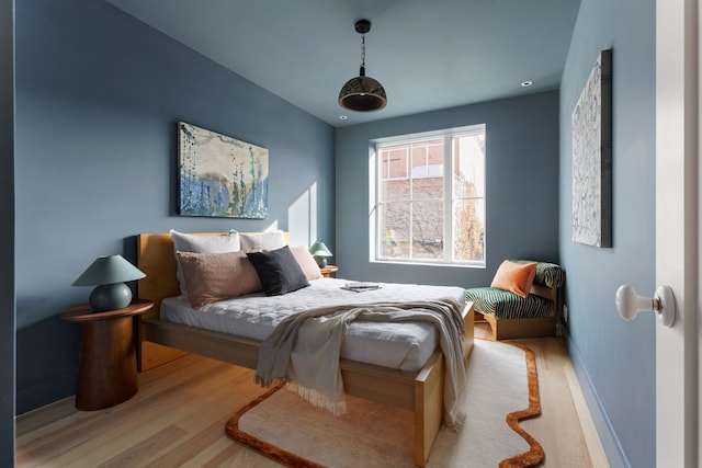 bedroom featuring baseboards and wood finished floors