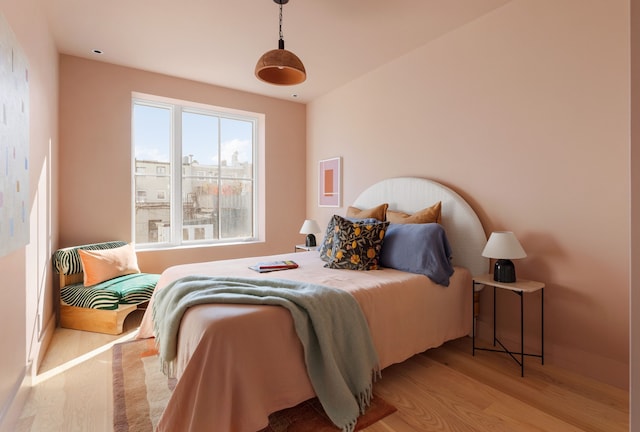 bedroom with wood finished floors and baseboards