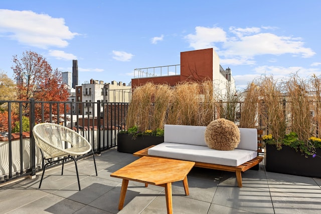 view of patio / terrace with a balcony and a city view