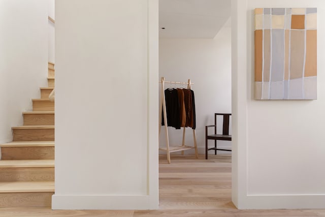 hallway featuring stairway and wood finished floors