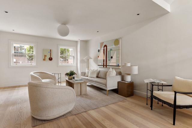 living area featuring light wood-type flooring and baseboards