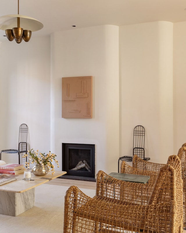 living area with carpet and a fireplace