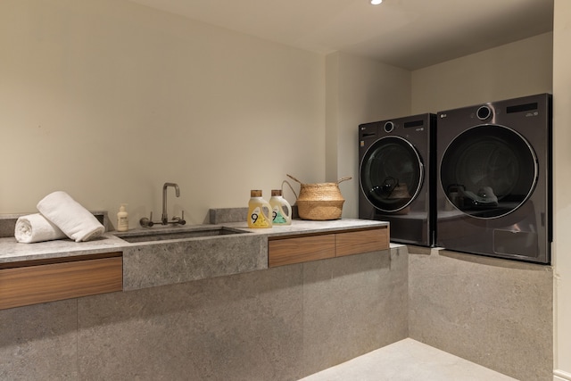 laundry area with a sink and washing machine and clothes dryer