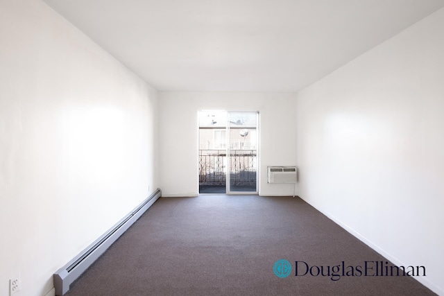 empty room with baseboards, a wall mounted AC, dark colored carpet, and a baseboard radiator