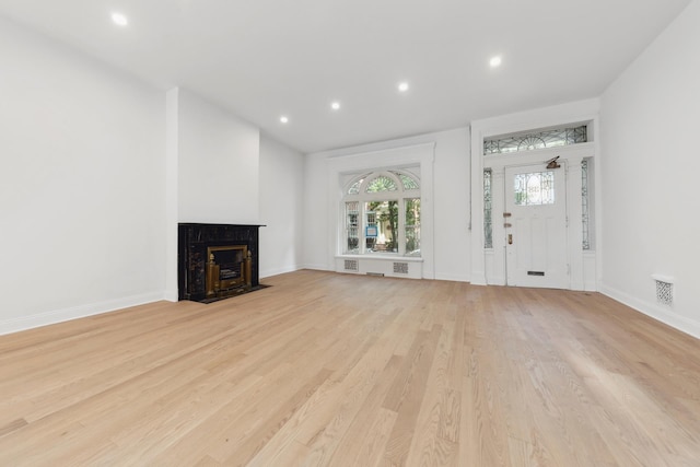 38 W 11th St, New York City, NY 10011 - unfurnished living room featuring light wood-style flooring, a high end fireplace, and recessed lighting