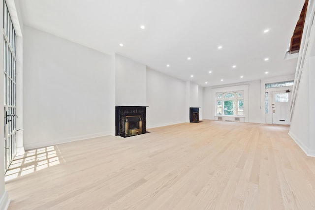 38 W 11th St, New York City, NY 10011 - unfurnished living room with a fireplace, light wood finished floors, and recessed lighting