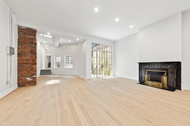 38 W 11th St, New York City, NY 10011 - unfurnished living room with light wood-style flooring, recessed lighting, and a fireplace with flush hearth