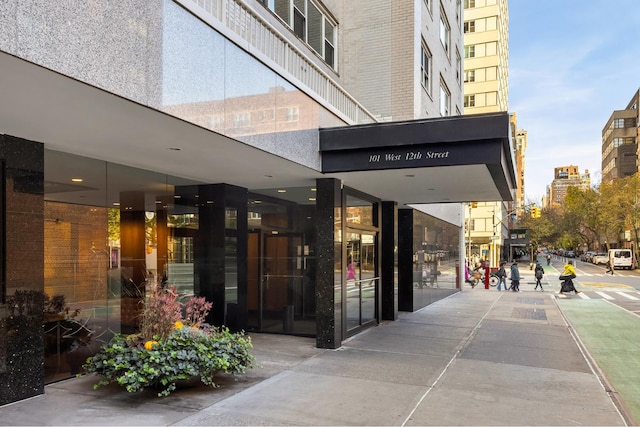 property entrance featuring a view of city and brick siding