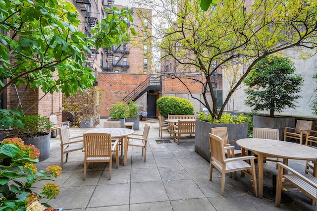 view of patio with outdoor dining space and a fireplace