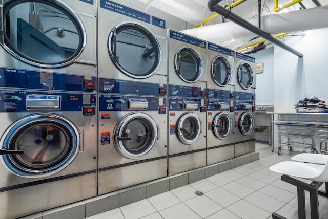 common laundry area with stacked washer / dryer, independent washer and dryer, and tile patterned floors