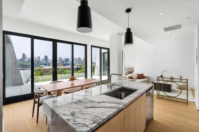 30-05 Vernon Blvd Ph-A, Ph-A New York City, NY 11102 - kitchen with a skyline view, light stone counters, decorative light fixtures, french doors, and modern cabinets
