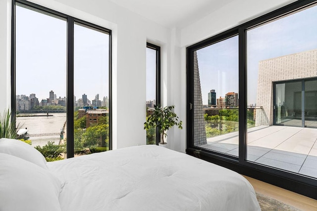 30-05 Vernon Blvd Ph-A, Ph-A New York City, NY 11102 - bedroom featuring a skyline view, wood finished floors, and a water view